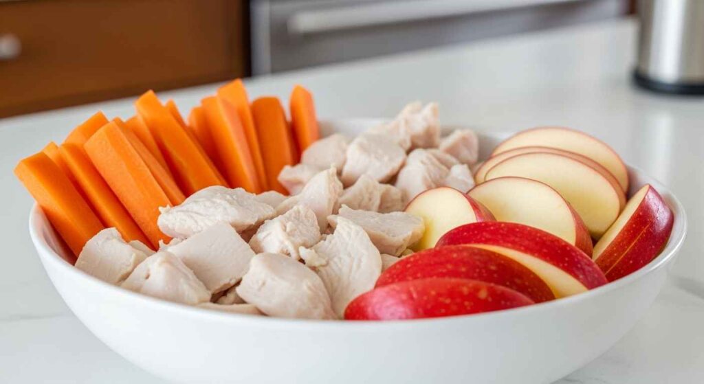 Bowl of carrots and chicken for dogs.